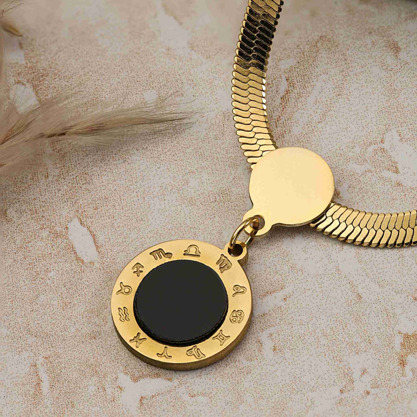 gold snake chain round black pendant