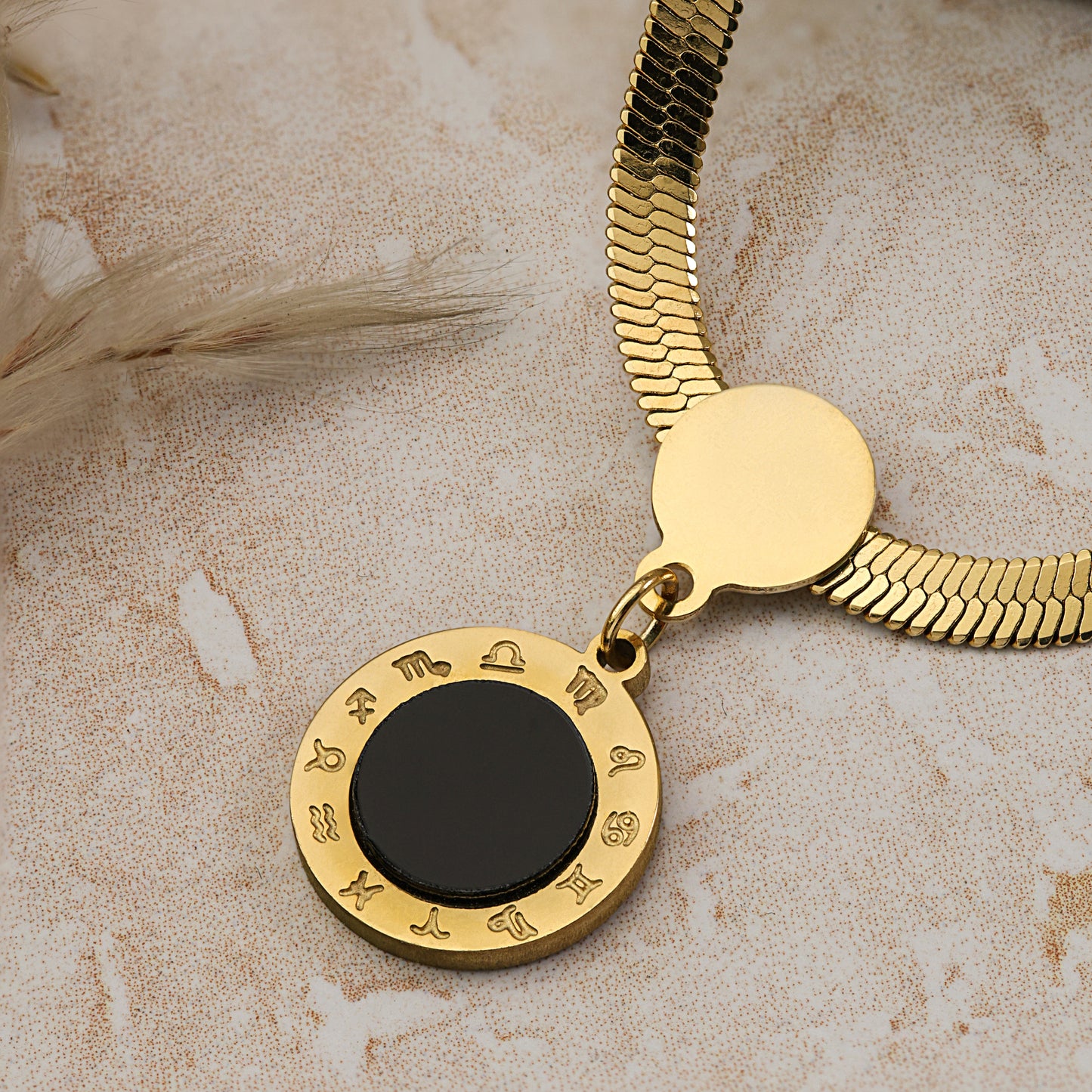 gold snake chain round black pendant 